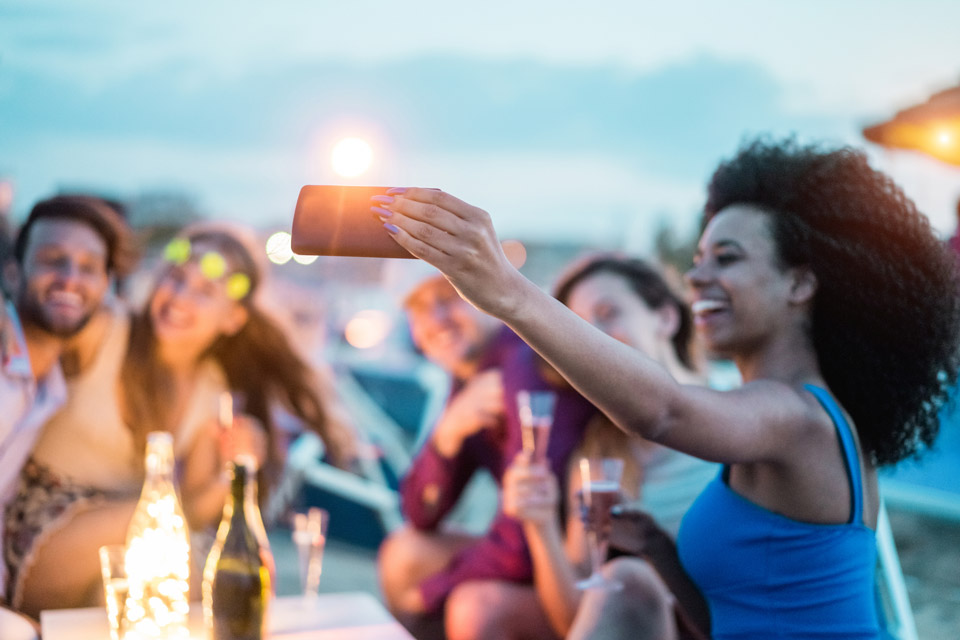 Friends gathered celebrating while taking a selfie